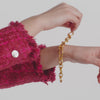 carousel; video of model putting on catalina demi link bracelet